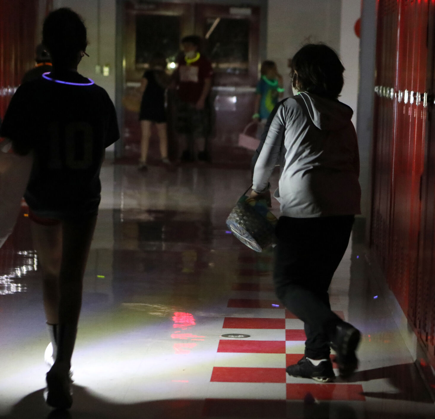 Children run through a hallway looking for eggs